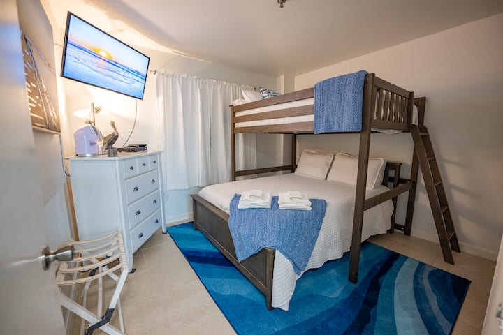 Bedroom 2 features a luxury mattress Queen Bed and a Full bunk on top.