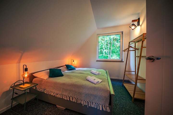 Útulný úkryt s pohodlnou veľkou posteľou.  Jemné farby ideálne na pokojný spánok.