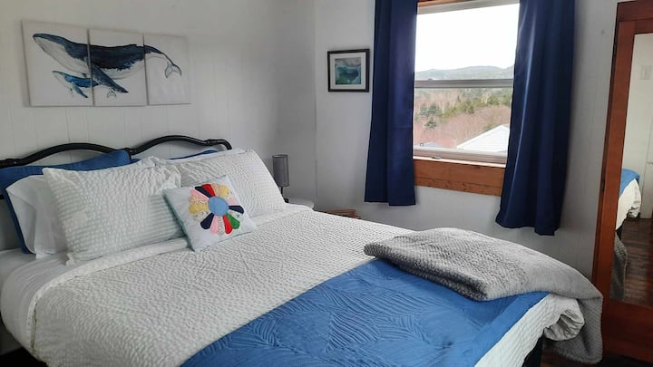 Cozy queen bed with wardrobe.