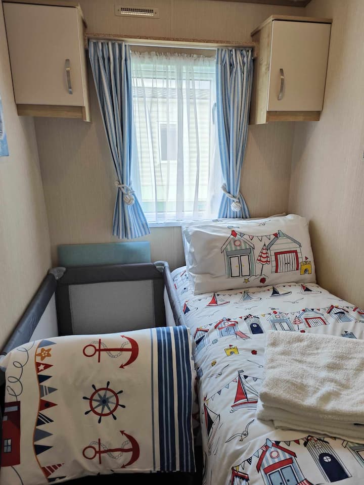 Bedroom 3 can be set up as two single beds, one single bed, or one single bed and one baby travel cot. We have two bed guards available at the caravan for your use should you need them.