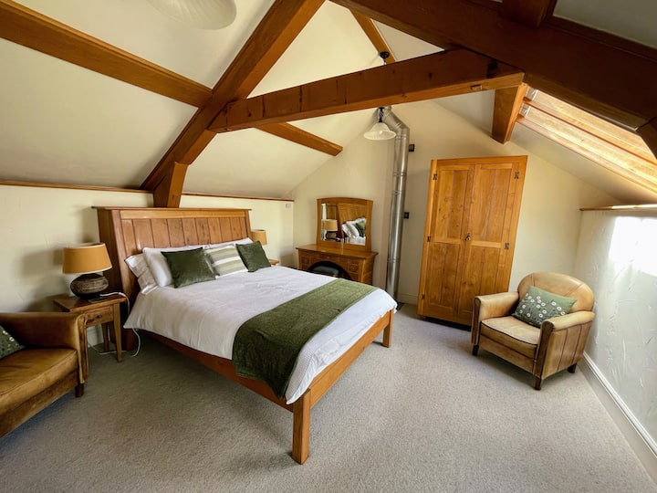 The cosy double bedroom features a handmade oak king sized bed and furniture...