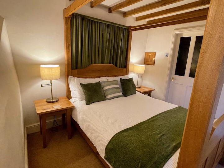 The master bedroom features a contemporary styled king-size four-poster bed.