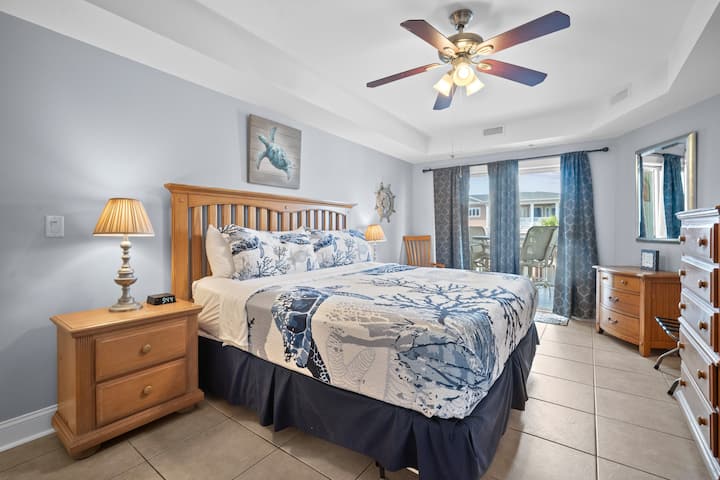 King size bed with night stands and access to balcony; Xfinity app allows you to login to your Hulu, Netflix and more;  Closet with hangers, dresser for storage, luggage rack; walk in closet has LOTS OF BEACH accessories such as chairs, toys, etc.  