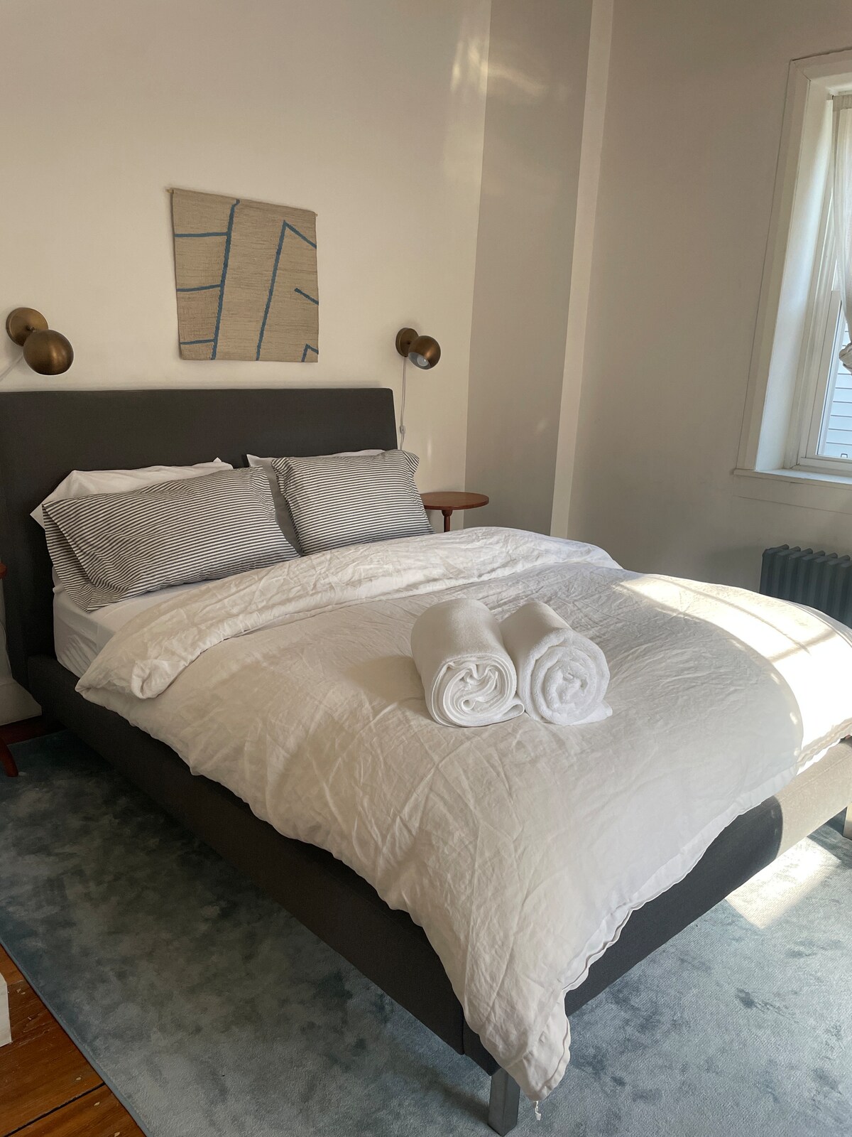 The primary bedroom has a queen-size bed with new luxury mattress from Saatva. It has south-west facing windows that face the rear of the house, away from any street-side noise. 