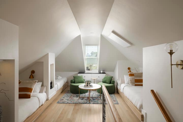 The loft bedroom boasts three twin beds, each decked out with its own reading lamp. Plus, two of them come with their very own TVs!