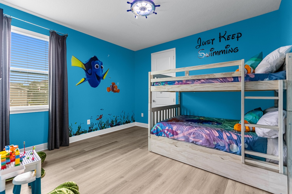 חדר שינה מקסים בנושא נמו עם מיטות קומתיים מרווחות ומלאות, מושלם למשפחות או חברים, עם עיצוב שובב שמשקיע את האורחים בעולם האוקיינוסים.
