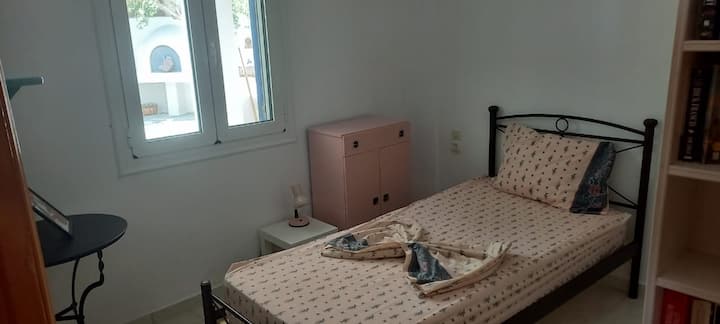 Single bedroom on the ground floor, with fitted wardrobe and patio view.