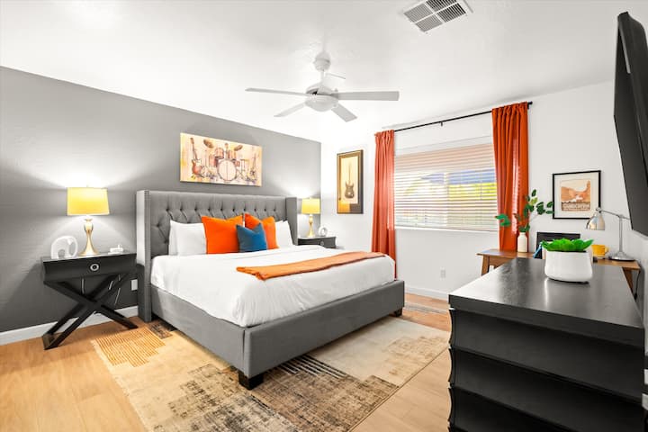 Master bedroom with king bed, desk and chair