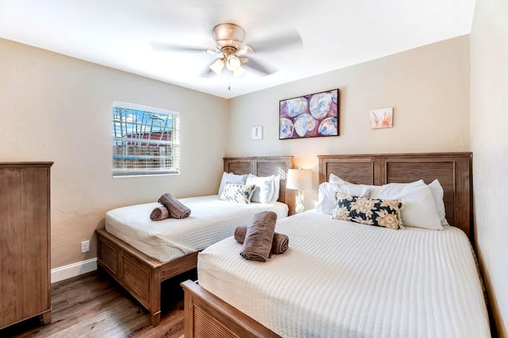 Cozy bedroom featuring two comfortable double beds, perfect for a restful night's sleep with plenty of space for everyone.