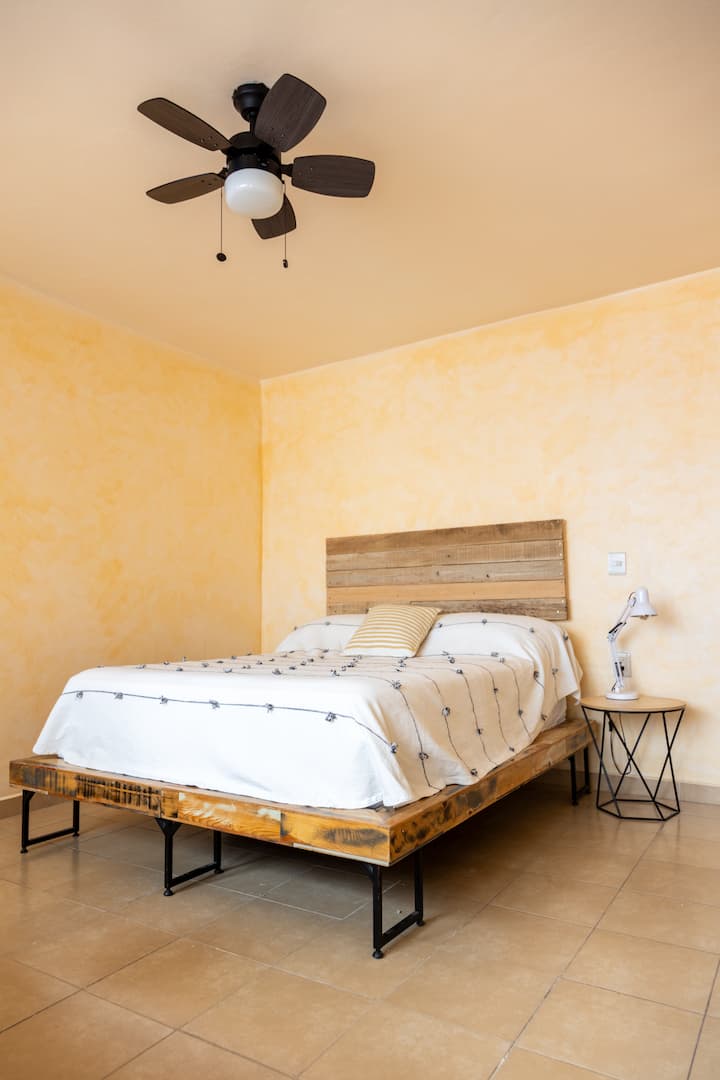 Соба со брачен кревет (широк 150-179 см). Има големо работно биро и тавански вентилатор