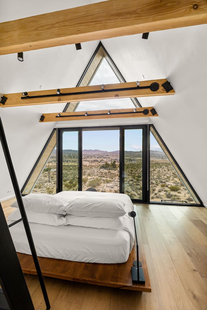 All-glass wall with a Juliet balcony in the upstairs bedroom