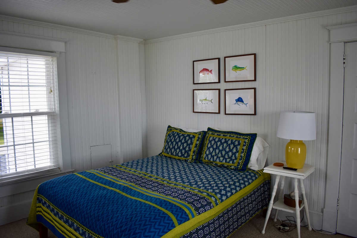 Upstairs Bedroom #2 overlooking the water with Queen Platform Bed, FireStick TV, and Reading Chair