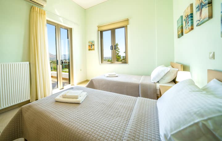 Upper Level: Bedroom 5 with two single beds and balcony with view