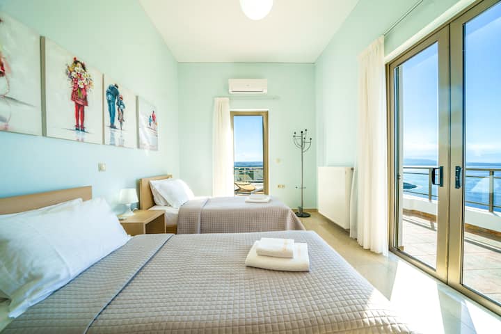 Upper Level: Bedroom 3 with two single beds and balcony with sea view