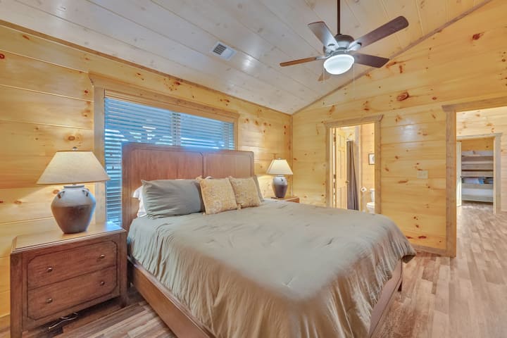 Suite principal: elegantes interiores de madera con iluminación suave y una lujosa cama tamaño king para noches de descanso.