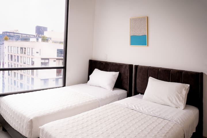 Camera secondaria con armadio e due letti singoli.