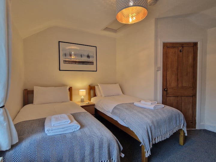 Twin bedroom with adult sized single beds