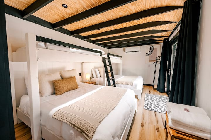 Two queen bunk beds, each topped with a twin bed, offer ample sleeping space for your group's mountain adventure. The striking contrast of black and natural wood creates a stylish and inviting atmosphere.
Photo: Chris & Pam Daniele