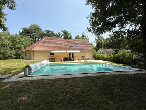 New house with swimming pool in a wooded area
