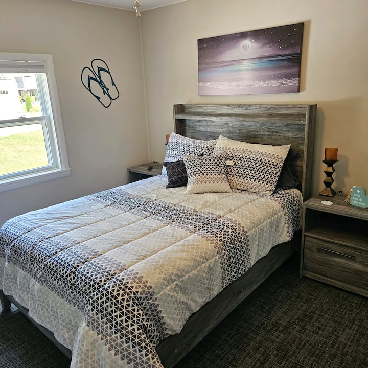Bedroom 3 features a double bed, large HDTV, whole house sound, and a ceiling fan. It is accessible via the main hallway with no exterior entrances.