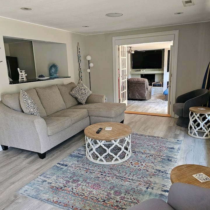 The main living room opens with French doors to the family room with views to the kitchen and dining room. Blackout blinds above the French doors can be lowered for privacy.