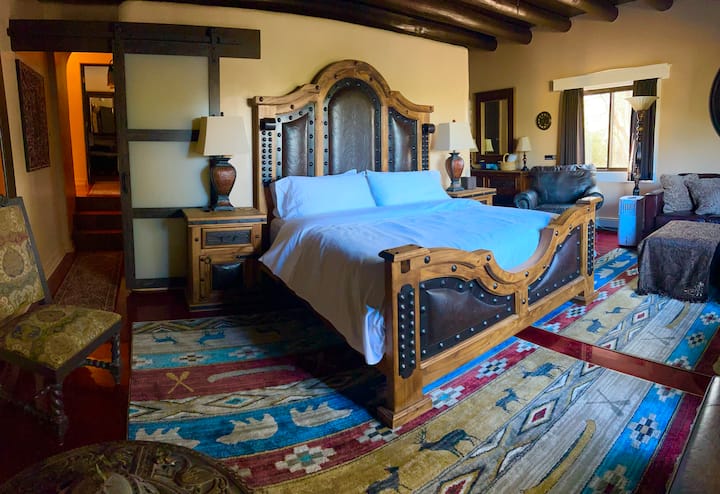 Huge King Suite with seating area for six . With 85' TV, walk in closet and full size appliances kitchenette you can have the whole group visit and watch a movie.  Guest favorite with Private porch and access to Hot Tub and Sauna.
