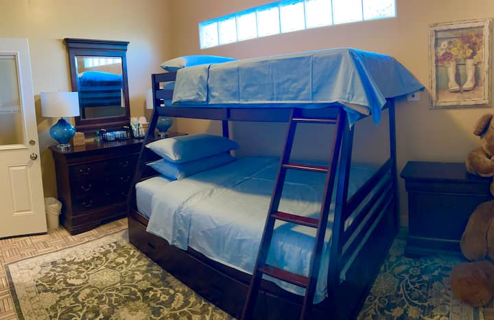 This kids Suite is equipped with a bunk bed, Double bed bottom and twin up top. This room is adjoining with our Full Suite. Kitchenette, Swim Spa , Sauna and Hot Tub just outside your door. Family Favorite.