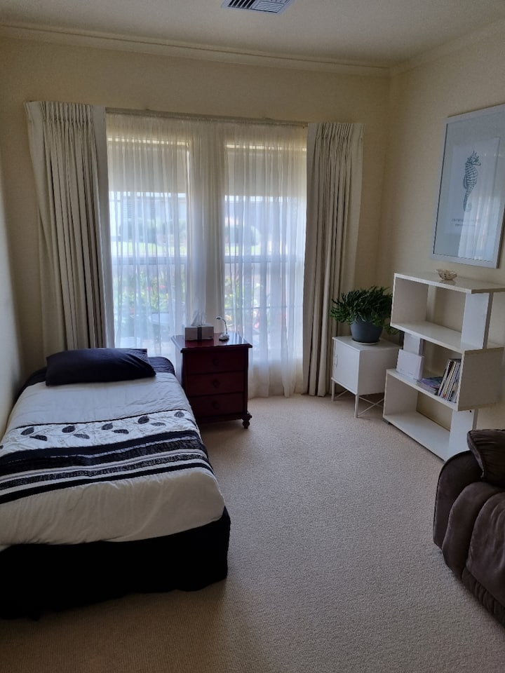 This room is entered through the two French doors with glass etching inserts. It has a single bed, an ornate windows overlooking the front garden, blockout curtains, a floor to ceiling 3 door built-in robe and a two-seater couch.