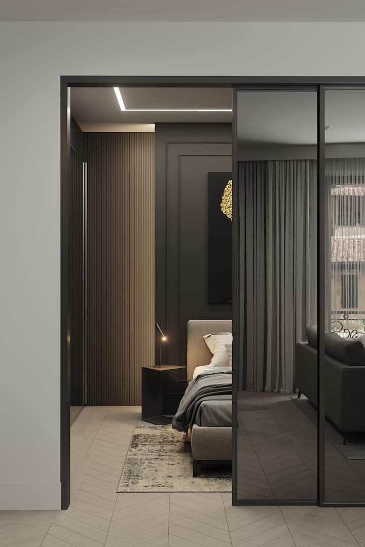 Soft grey living space with designer furnishings and direct access to bedroom.

