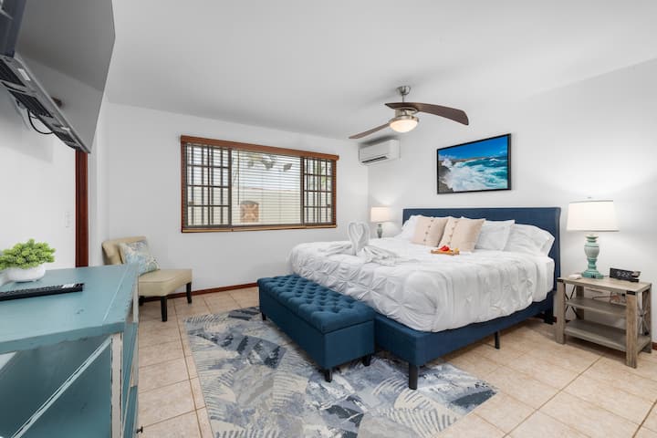 The primary suite — king bed, walk-in shower, soaking tub. You earned a nice bathroom.