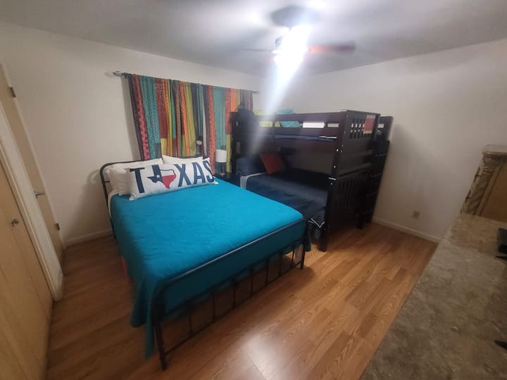 Guest bedroom with queen size bed and full over full bunkbed. 
Can sleep three adults and one child or teen less than 150 pounds in the upper bunkbed.