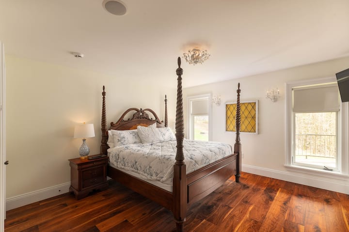 King bed in the bedroom suite part of the home; this bedroom has a private attached deck