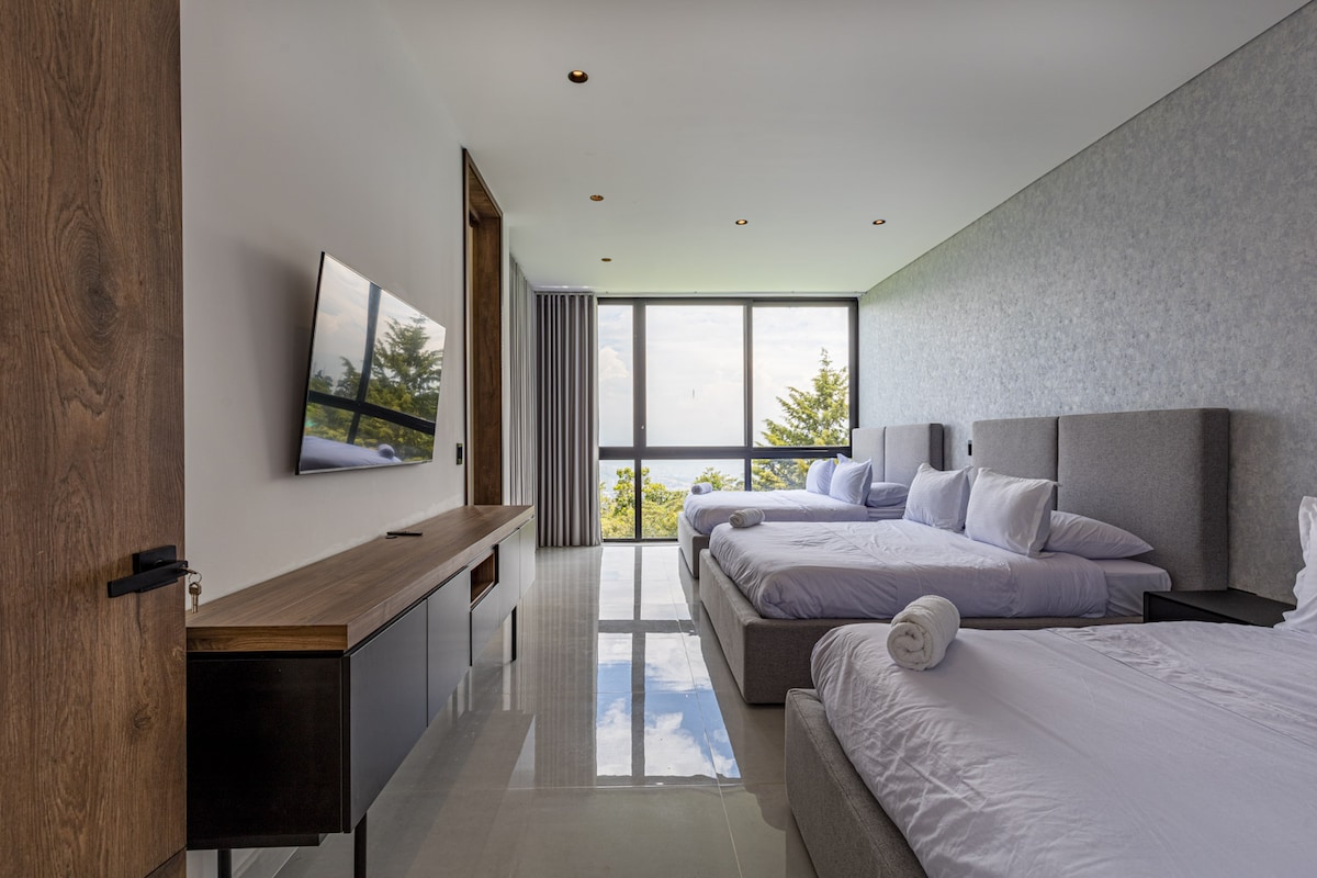 Con tres lujosas camas tamaño queen, Smart TV y vistas a la terraza, esta habitación es perfecta para familias o grupos que buscan comodidad, estilo y espacio para relajarse.


