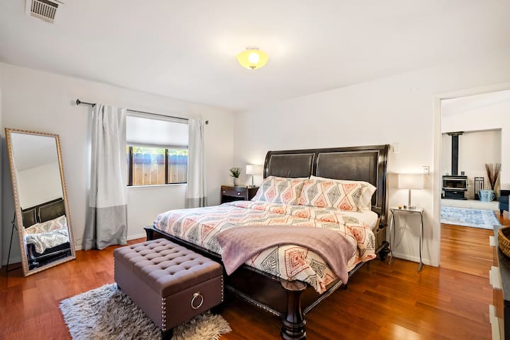 Large master suite at The Source Home, 1000 Kiler Canyon Road with king-size bed and full attached bathroom for privacy.