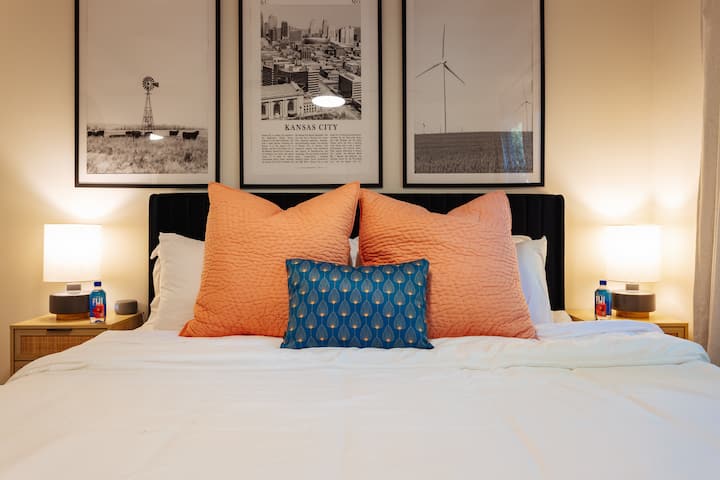 After a long day of travel enjoy this king bed and blackout curtains! Plush duvet bedding, soft and firm pillows, a sound machine, alarm clock, USB-C + A chargers, a ceiling fan, and Fiji water, all just for you.