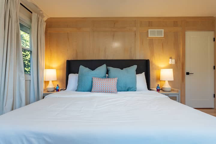 Your master bedroom is equipped with a king bed and plush duvet bedding, blackout curtains, soft and firm pillows, a sound machine, alarm clock, USB-C + A chargers, a ceiling fan, and Fiji water waiting to welcome you after a long day of travel.