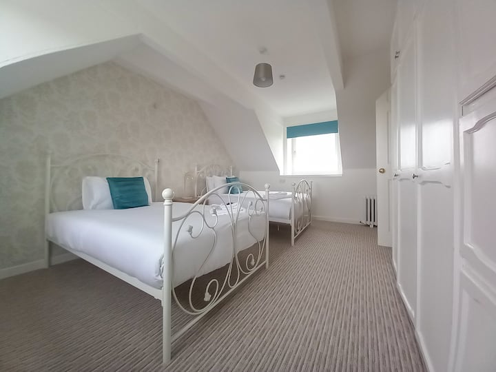 Boven tweepersoonskamer met 2 kleine tweepersoonsbedden. Dubbel aspect met breed landelijk uitzicht.