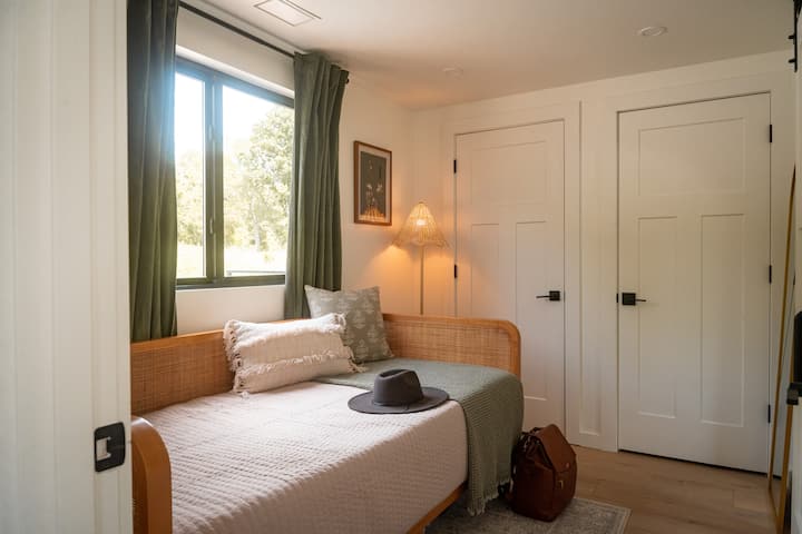 Charming Guest Room: Bright sunlight streams in, highlighting chic decor and stylish furnishings!