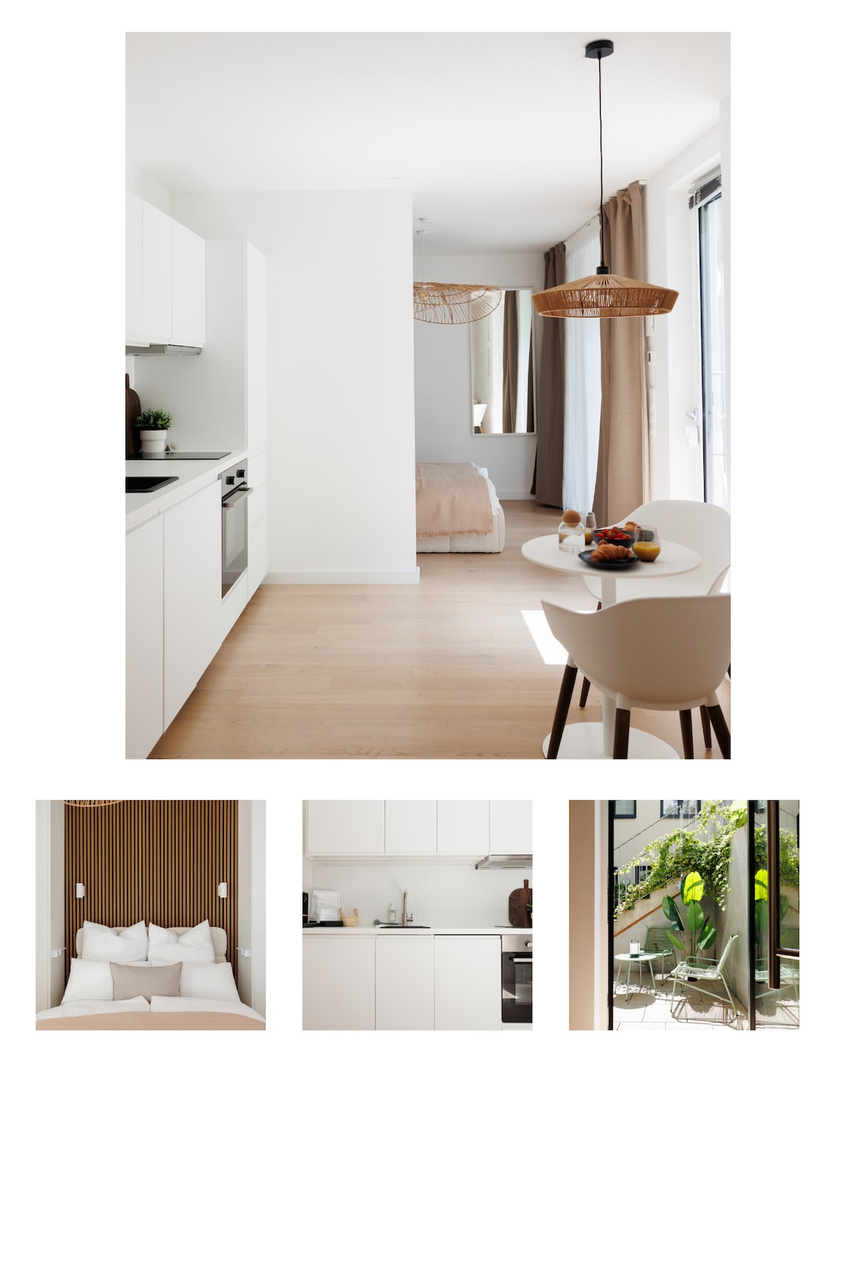 A modern kitchen area is displayed, featuring sleek white cabinetry and appliances. A small dining table with two beige chairs is positioned nearby, accompanied by a bowl of fresh fruit. Light enters through large windows, enhancing the bright, open atmosphere of the space.
