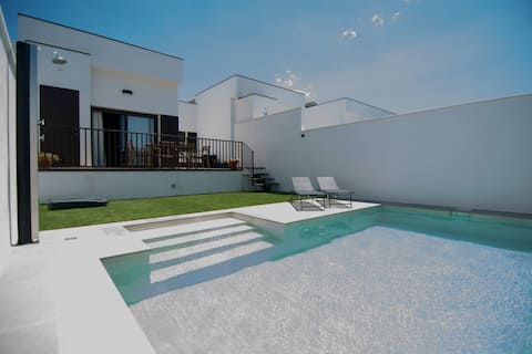 A villa with a private pool and garden