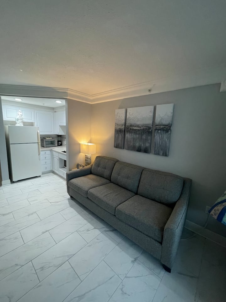 Queen sofa bed with kitchen alcove in the background