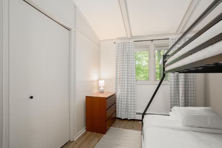Bunk room with twin on top and full-sized mattress on the bottom. A pack and play/crib with changing table is also available and stored in the closet.