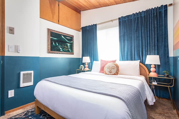 The second bedroom offers a queen-sized memory foam bed. Wireless chargers are available on both nightstands. 