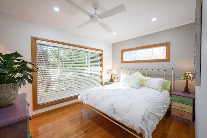 Master bedroom with ceiling fan and ensuite