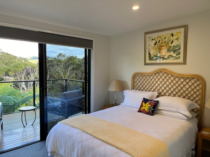 Cama tamaño queen y acceso a tu propia terraza privada con hermosas vistas al bosque.