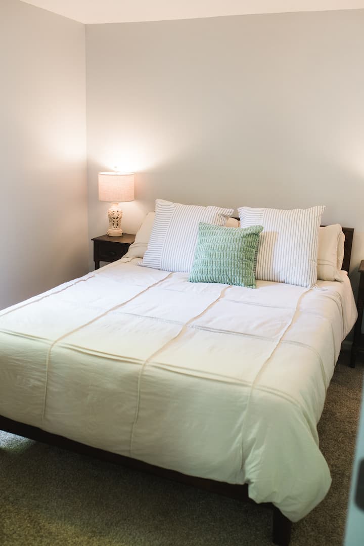 Queen bed in the bedroom upstairs.