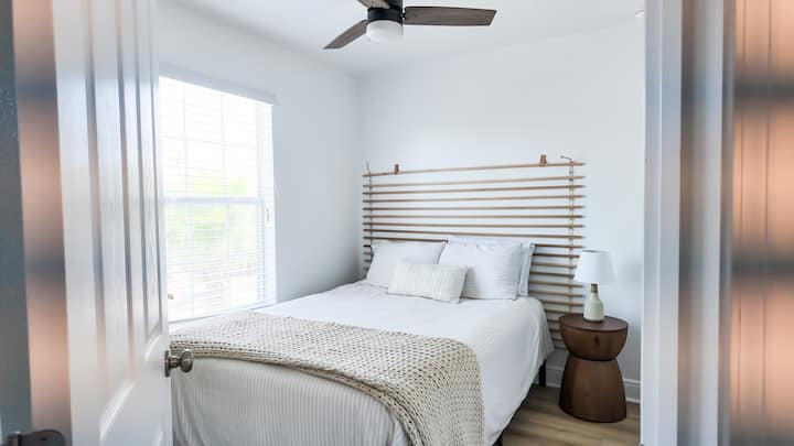 Cozy and bright, the second bedroom features a comfortable queen-size bed, TV, soft linens, and a calming atmosphere, perfect for a restful night's sleep.