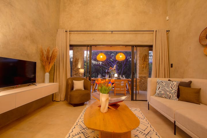 Grote luxe open woonkamer met toegang tot buiteneethoek.