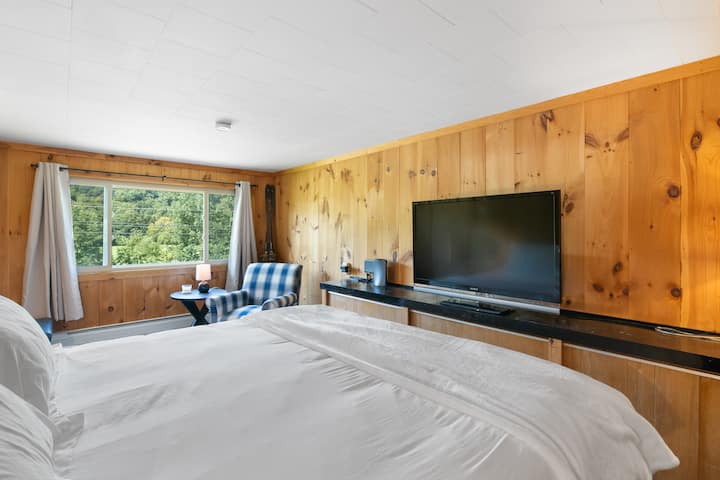 Primary bedroom includes a king bed, blackout shades, closet, and smart TV. There is a portable air conditioning unit in this bedroom if needed
