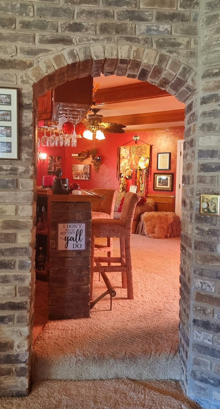 This home has more English brick than a posh pub in the Cotswolds. From the sunken living room you have a lovely view straight through to the lounge — the sort of spot where you half expect a butler to be there to hand you a glass of sherry.